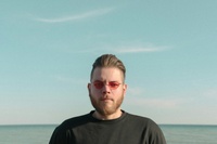 man in black crew neck shirt wearing eyeglasses